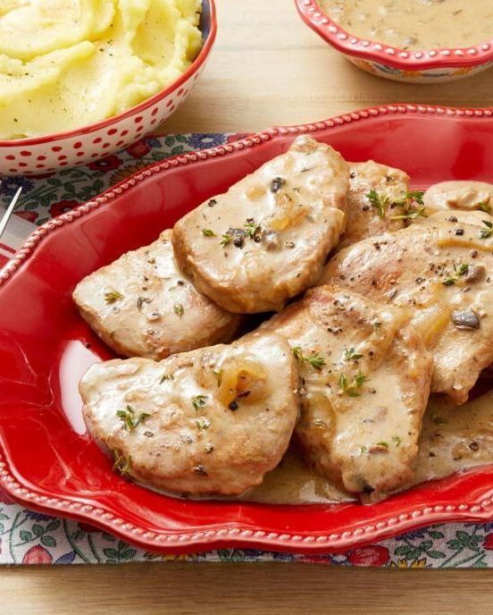 slow cooker pork chops with gravy on red plate