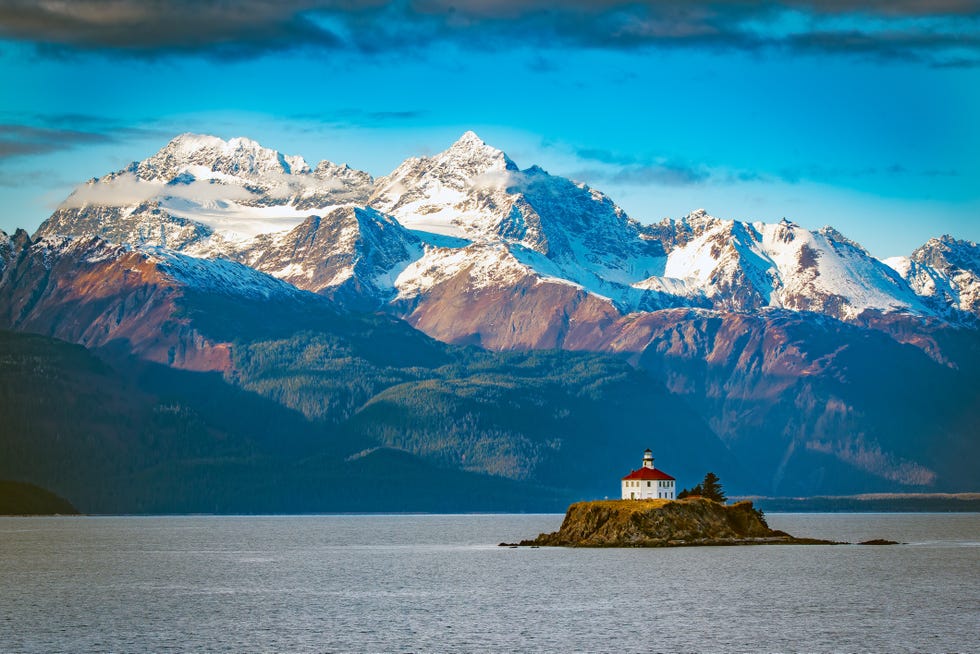 view of the eldred rock lighthouse, a historic lighthouse adjacent to lynn canal in alaska it is the end of october with fresh snow on the mountains in the background this wooden octagonal lighthouse was opened in 1905 and is 56 feet in height the nearest city is haines, alaska which is reached by ferry from the south or by highway from the yukon to the north historic skagway, alaska is also nearby this lighthouse is in the northwestern united states of america usa