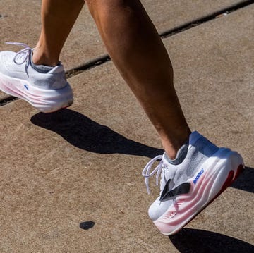 bottom half of someone's legs running down a pavement in white and pink shoes bottom half of someone's legs running down a pavement in white and pink shoes