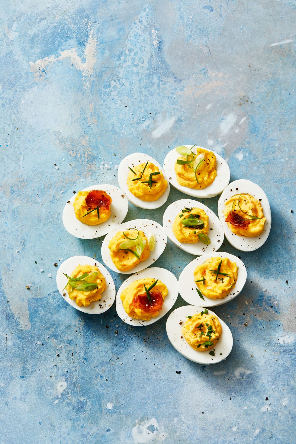 deviled eggs with assorted toppings