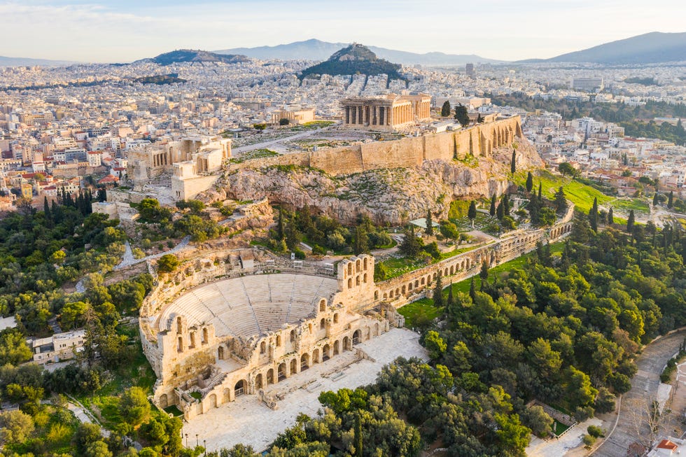 this is a drone photo of the odeon of herodes atticus and the acropolis of athens, greece the theater was renovated in the 1950s and it is used for theatrical plays and concerts in the summer