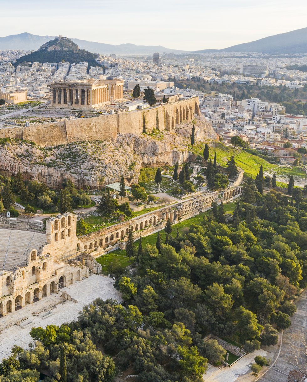 this is a drone photo of the odeon of herodes atticus and the acropolis of athens, greece the theater was renovated in the 1950s and it is used for theatrical plays and concerts in the summer