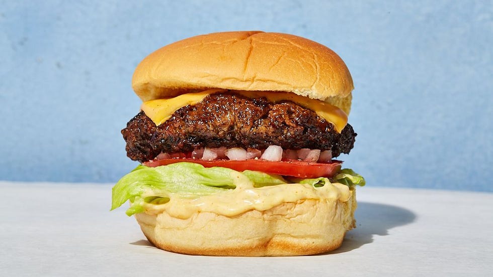 cheeseburger with onions, tomatoes, lettuce and sauce