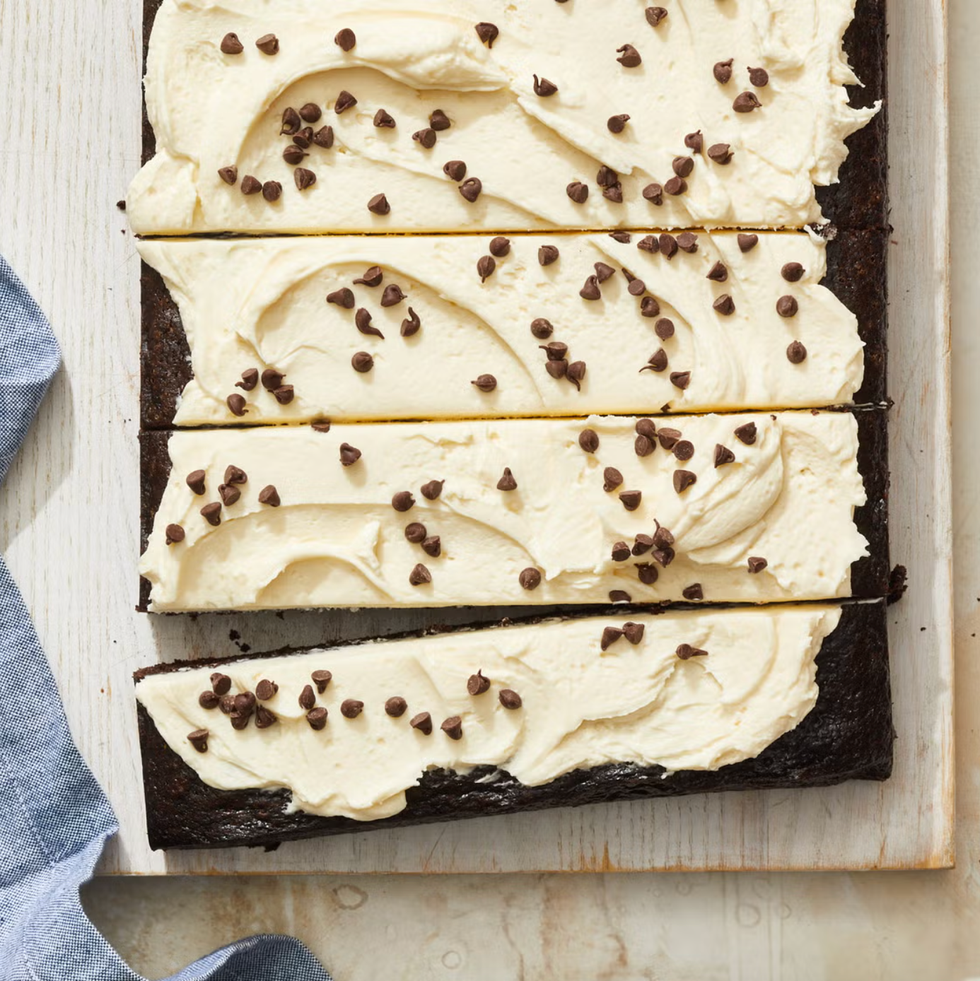 chocolate cake with white frosting and chocolate chips on top