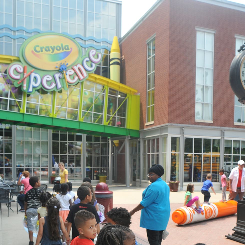 the exterior of the crayola experience, with a class of children heading inside the crayola experience is a good housekeeping pick for best factory tours