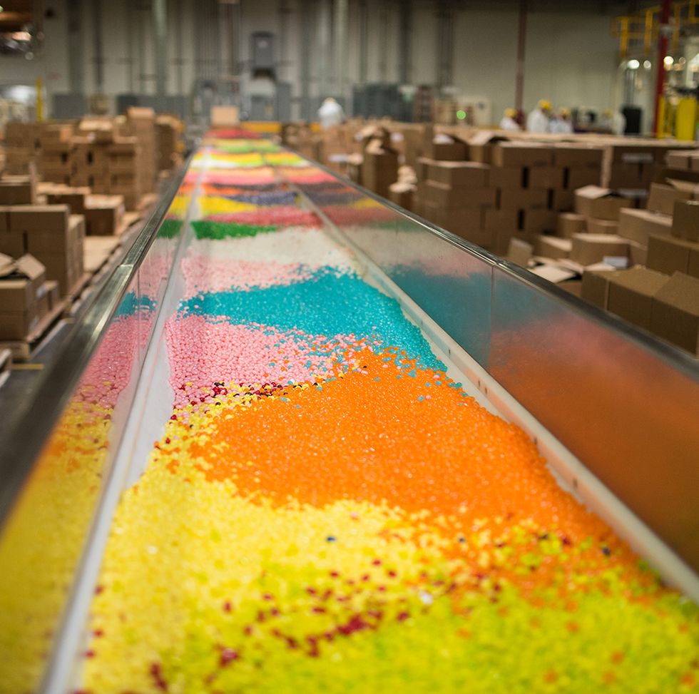brightly colored candies go down the mixing line in the jelly belly factory, a good housekeeping pick for best factory tours