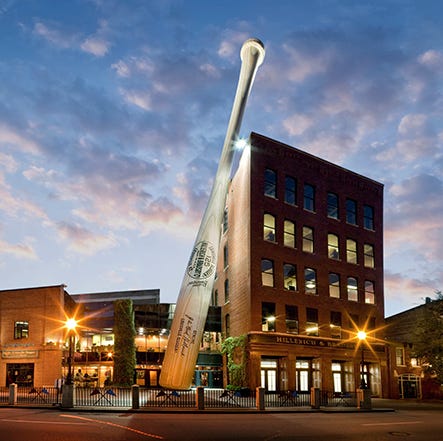 The exterior of the Louisville Slugger factory, a Good Housekeeping pick for best factory tours. The exterior features a building-sized baseball bat. the exterior of the louisville slugger factory a good housekeeping pick for best factory tours the exterior features a building sized baseball bat