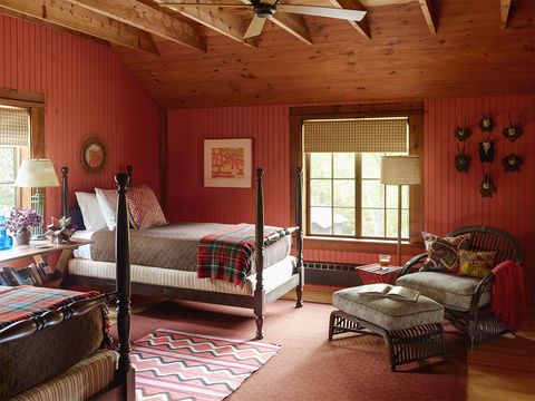 boston architect heather wells's cabin retreat in north sutton, new hampshire in a guest bedroom, the wicker chair and ottoman have cushions covered in an alan campbell fabric, the antique beds are dressed in utility canvas coverlets, and a vintage navajo rug is layered over a carpet by kasthall the pine walls are painted in benjamin moore's golden gate  for details, see resources  elle decor, december 2016