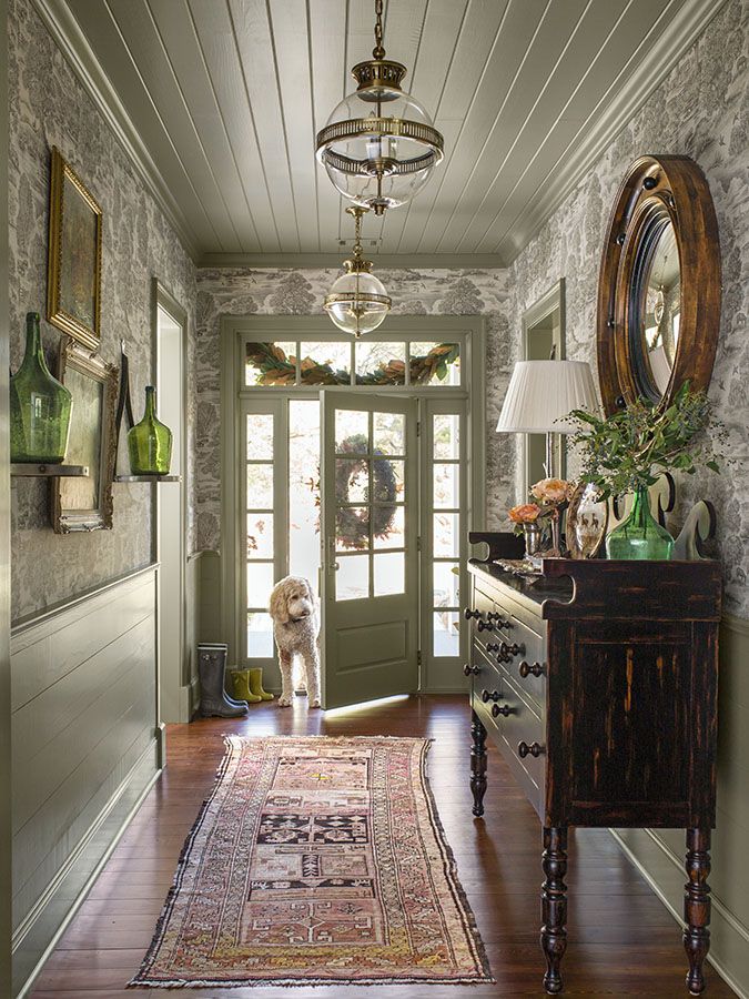 olive painted front entryway with toile wallpaper