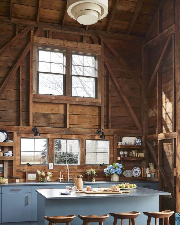 a barn like kitchen with the base cabinets painted a watery blue
