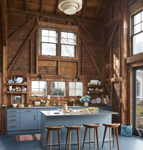 a barn like kitchen with the base cabinets painted a watery blue