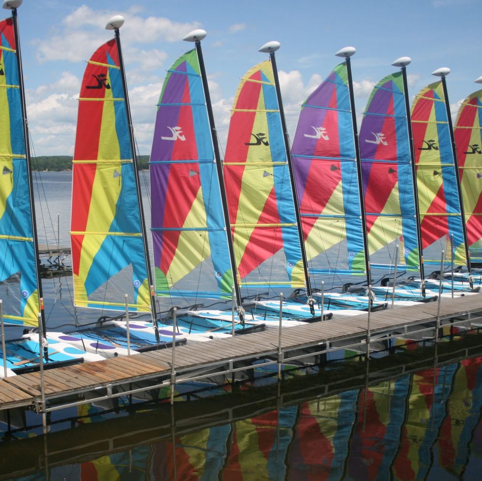 a lineup of sailboats along a dock at the tyler place family resort, a good housekeeping pick for best all inclusive family resorts