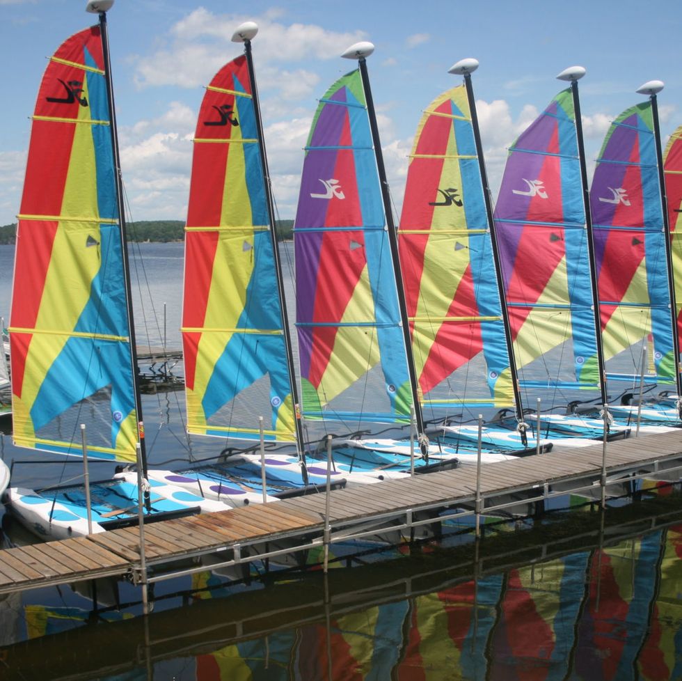 a lineup of sailboats along a dock at the tyler place family resort, a good housekeeping pick for best all inclusive family resorts