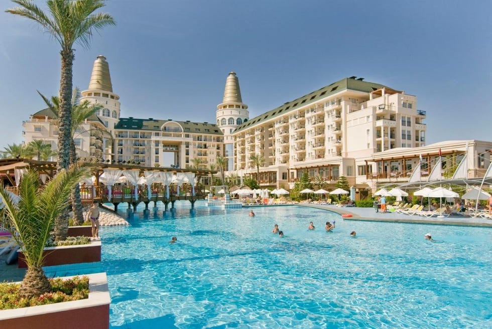 a pool with people in it and buildings in the back