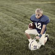 portrait of a young american boy ready to take the football field