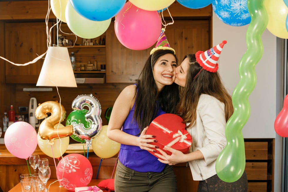 best friends at 23rd birthday party with balloons and party hats