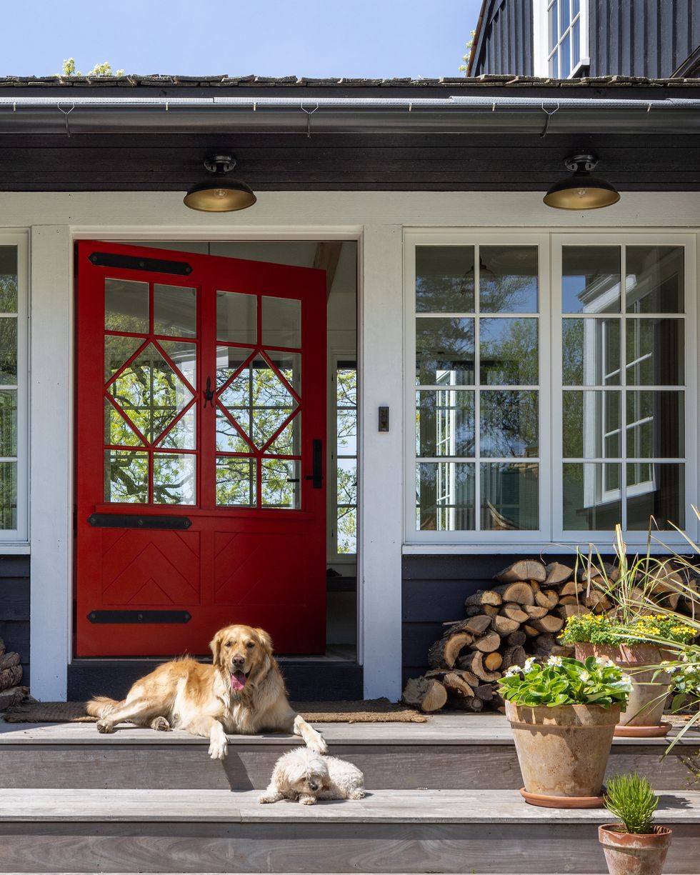 dark charcoal house with white trim and red front door