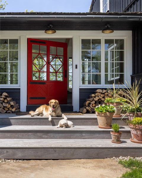 dark charcoal house with white trim and red front door