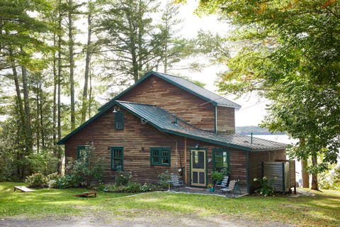 rustic lake cabin with golden yellow front door