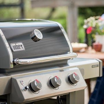 weber gas grill next to steak on grill