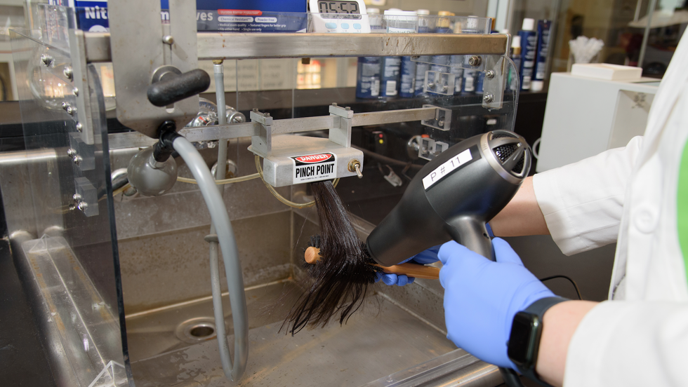 Best Hair Dryer for Curly Hair the good housekeeping institute beauty lab tests a hair dryer on a hair sample in lab