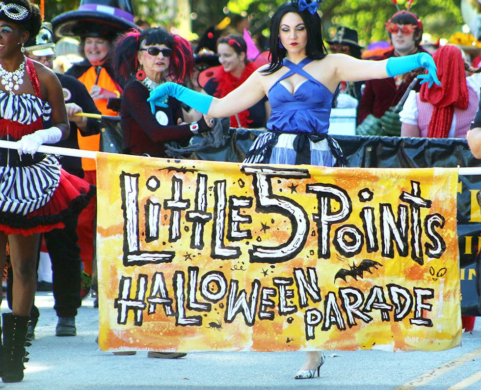 parade of adults wearing colorful halloween costumes at little five points halloween festival and parade in atlanta, georgia