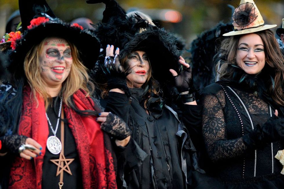 three women in halloween witch costumes and make at festival of the dead in salem, massachusetts