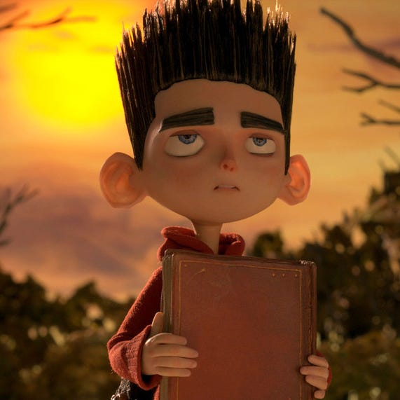 norman holds a mysterious book in a scene from 'paranorman,' a good housekeeping pick for best halloween movies for kids