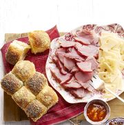 sliced ham and sliced cheese on platter with rolls