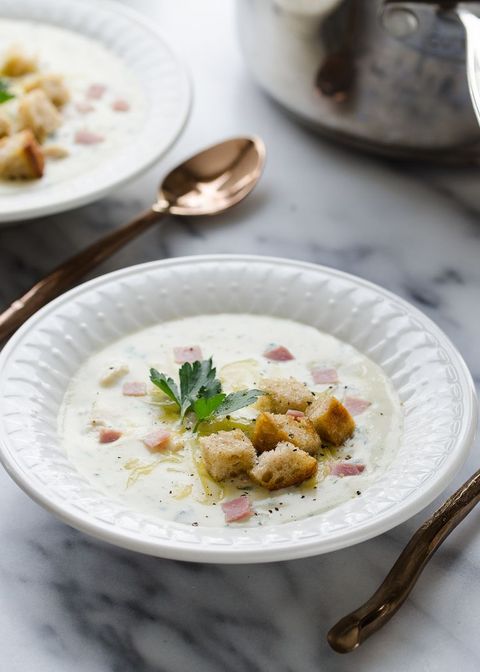 chicken cordon bleu soup with croutons and parsley in white bowl