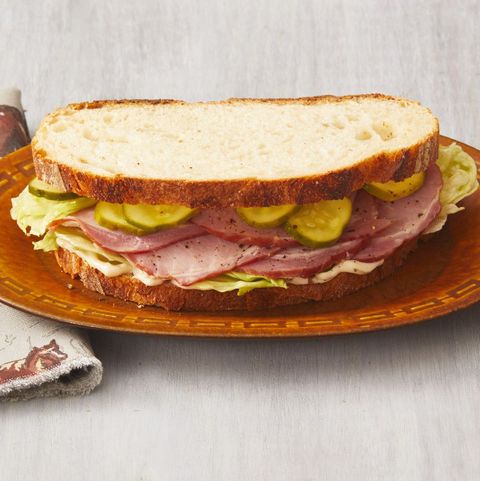 ham sandwich with quick pickles on brown plate