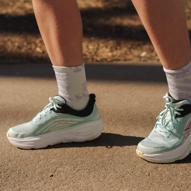 close up of the bottom half of someone's legs wearing a pair of green and black hoka running shoes and quarter length socks close up of the bottom half of someone's legs wearing a pair of green and black hoka running shoes and quarter length socks