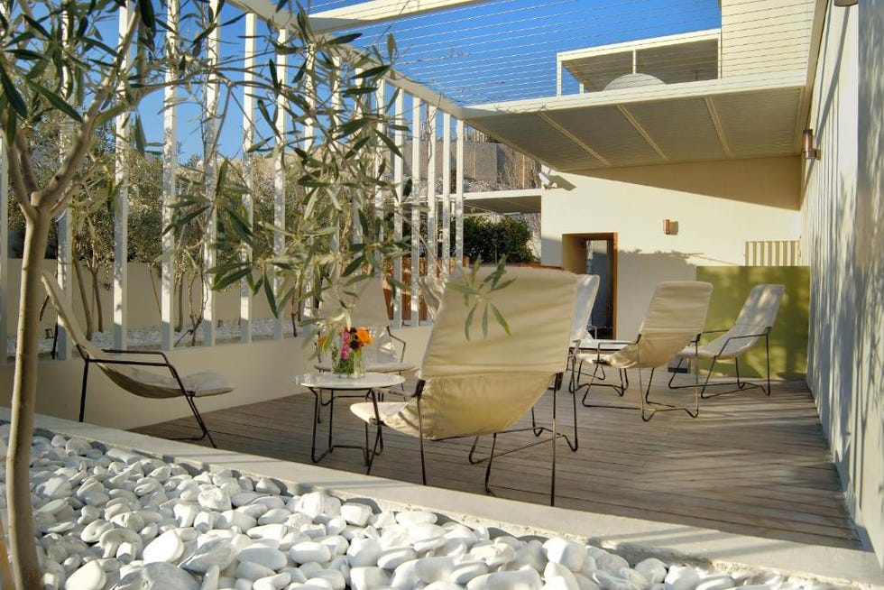 a patio with chairs and a table