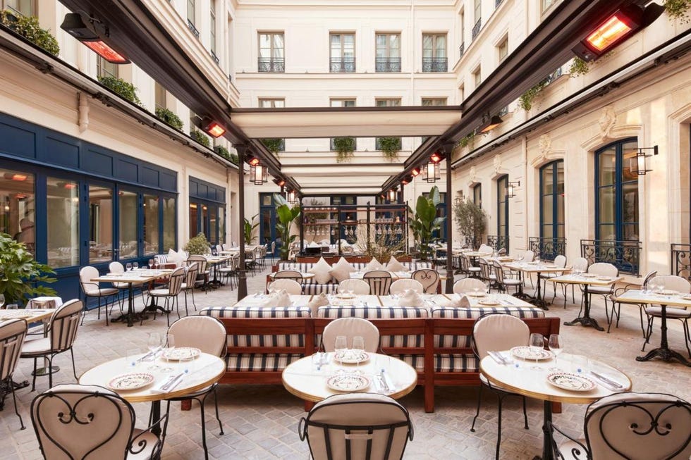 a group of tables and chairs outside