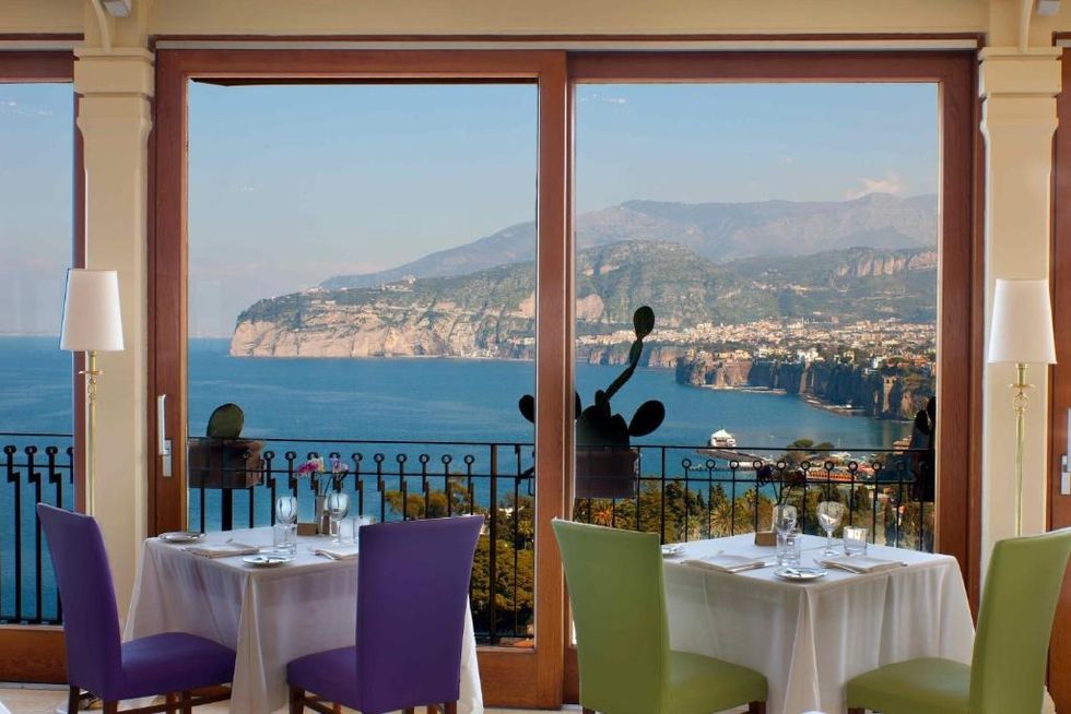 a table with a view of the ocean and mountains