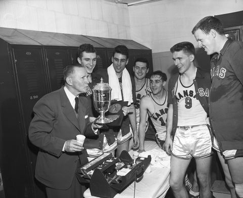 Coach and Kansas University Basketball Players with Trophy