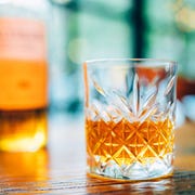 best irish whiskey single glass of whisky or whiskey and whiskey bottle on wooden table