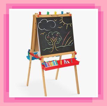 wooden kids easel with a drawing of a tree and sun