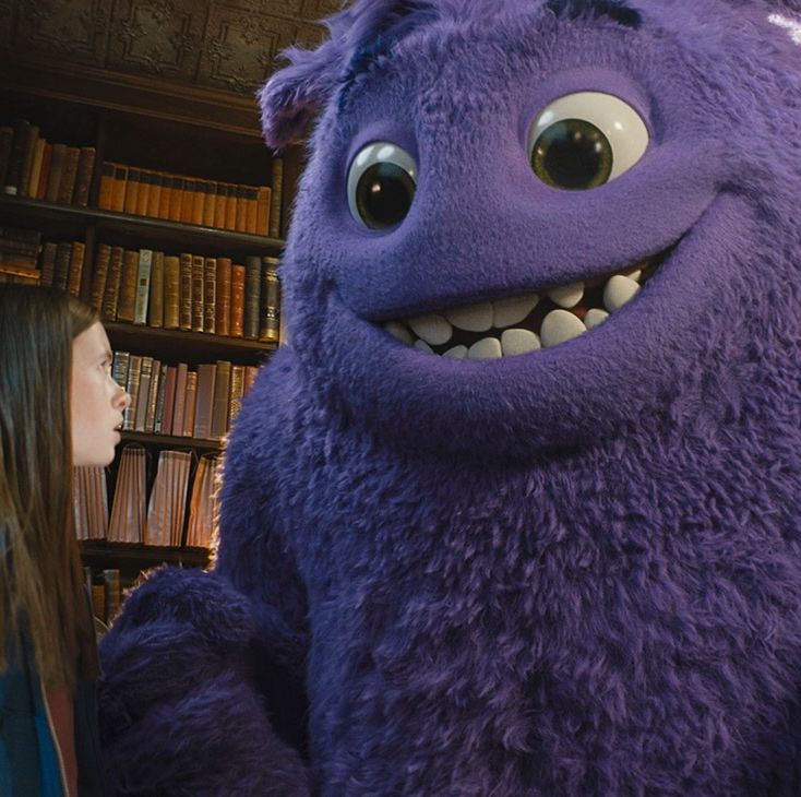 a big, purple imaginary friend smiles at a little girl