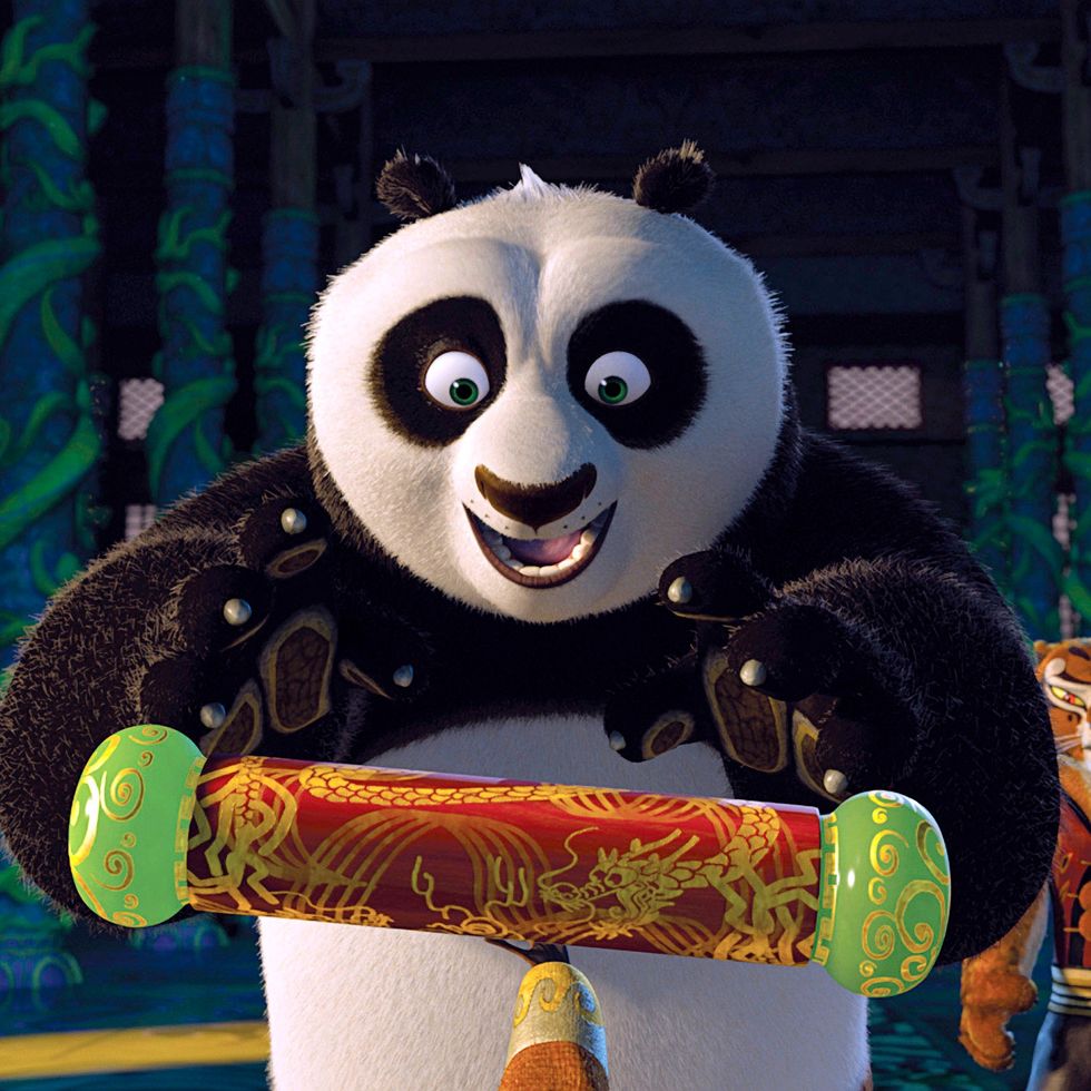 po holds a cylindrical object in is hand with wonder in a scene from kung fu panda