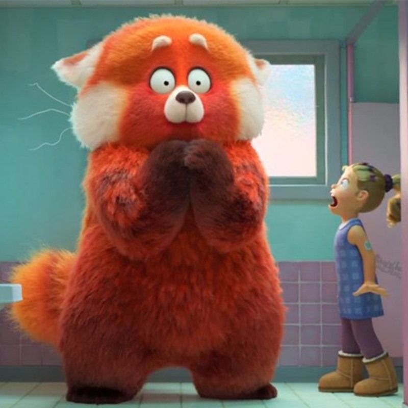 a giant red panda surprises a middle school student in the school bathroom in a scene from turning red