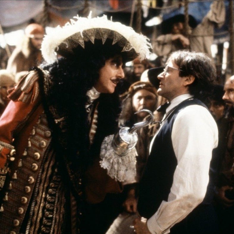 captain hook menaces an adult peter pan in a scene from hook