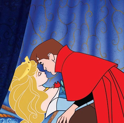 the prince leans in to give a kiss to an enchanted princess aurora in a scene from sleeping beauty