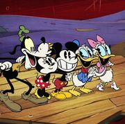 goofy, minnie, mickey, donald and daisy stand on a pier in a scene from the wonderful world of mickey mouse the show is a good housekeeping pick for best kids tv shows