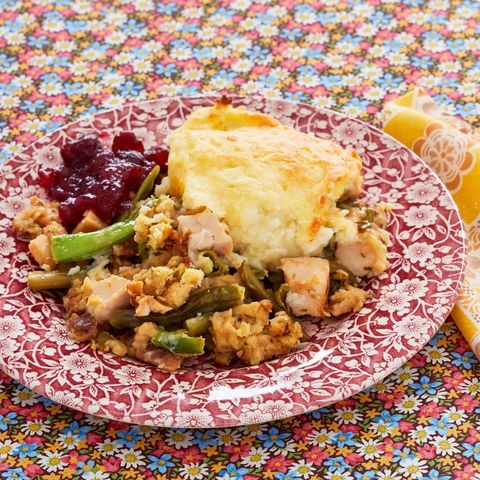 thanksgiving leftover casserole on plate with cranberry sauce