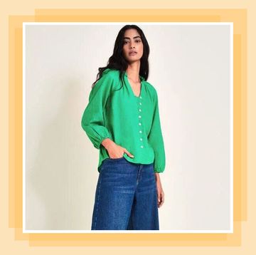 a woman in a green linen top and jeans