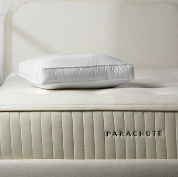 a white bed with a white pillow