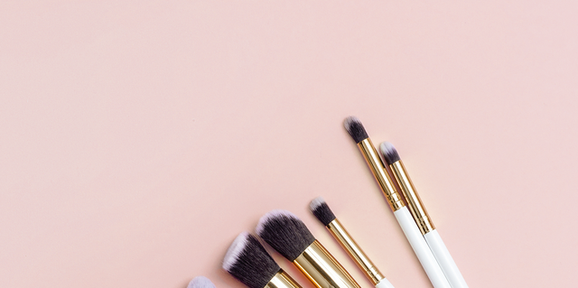 Various Make-Up Brushes On Pink Background