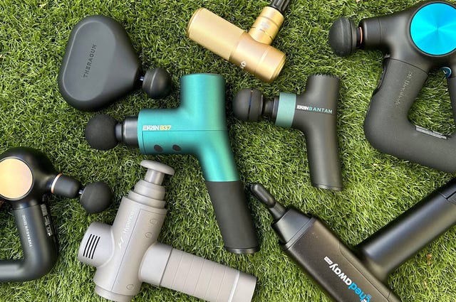 a selection of massage guns on astro turf