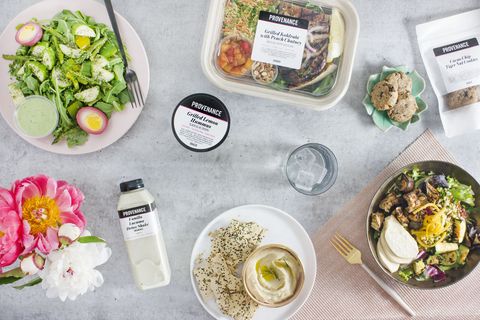 an assortment of prepared salads and hummus on a marble table from provenance meals, a good housekeeping pick for best healthy meal delivery service